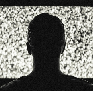 man in front of grainy tv
